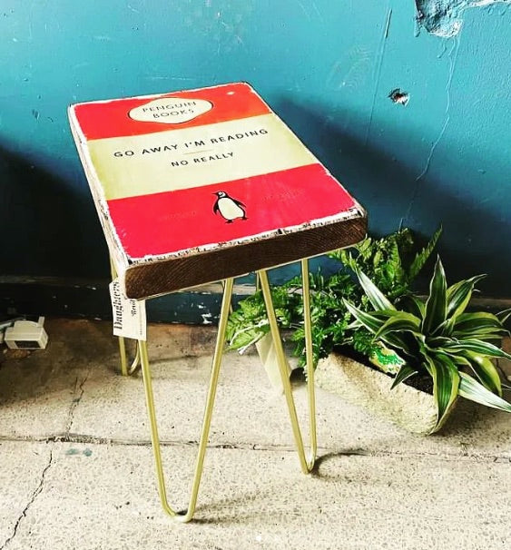 Stool with a Penguin Books design against a blue wall